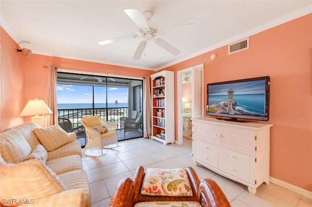 tiled living room featuring ornamental molding and ceiling fan