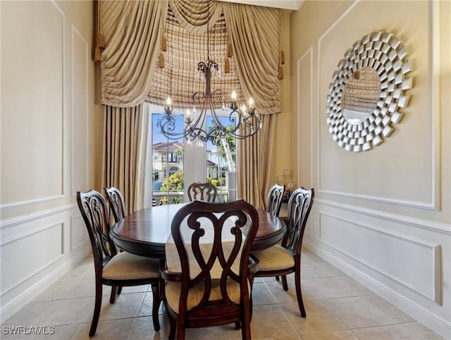 tiled dining room with a chandelier