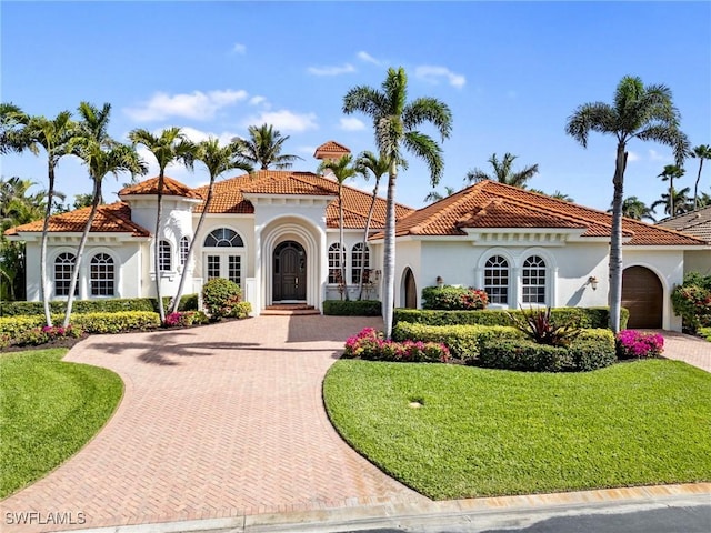 mediterranean / spanish house with a front yard