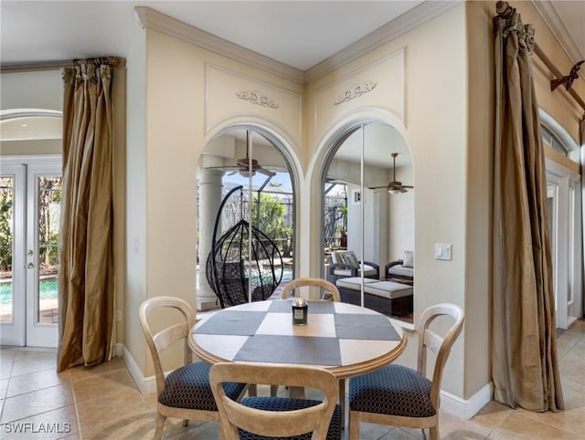 dining area with plenty of natural light, light tile patterned floors, ceiling fan, and french doors