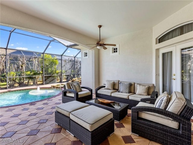 view of patio / terrace with an outdoor living space, ceiling fan, a lanai, and pool water feature