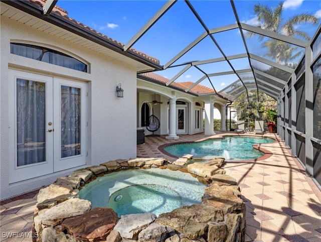 view of swimming pool with an in ground hot tub, a patio, glass enclosure, and french doors