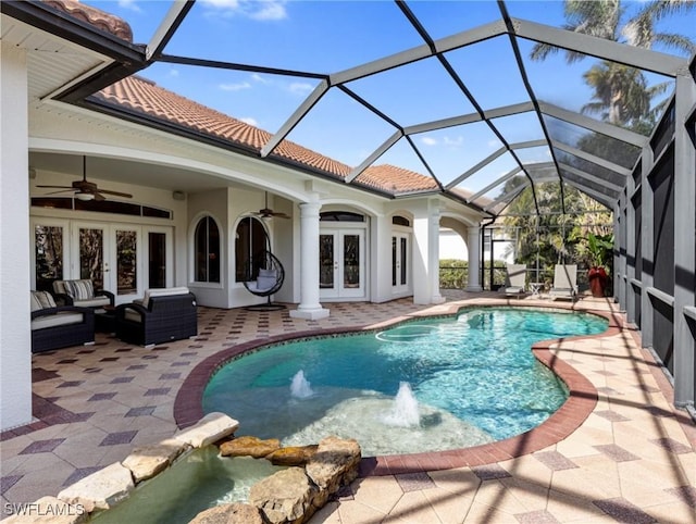 view of swimming pool with a patio area, ceiling fan, and french doors