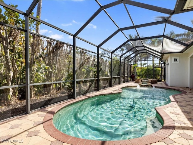 view of swimming pool featuring a lanai and a patio area