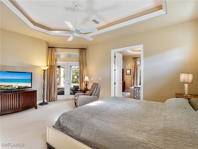 carpeted bedroom featuring access to outside, a raised ceiling, ceiling fan, and french doors