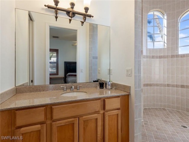 bathroom featuring vanity, plenty of natural light, and a shower