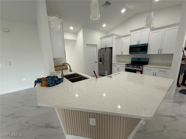 kitchen featuring sink, vaulted ceiling, appliances with stainless steel finishes, pendant lighting, and white cabinets