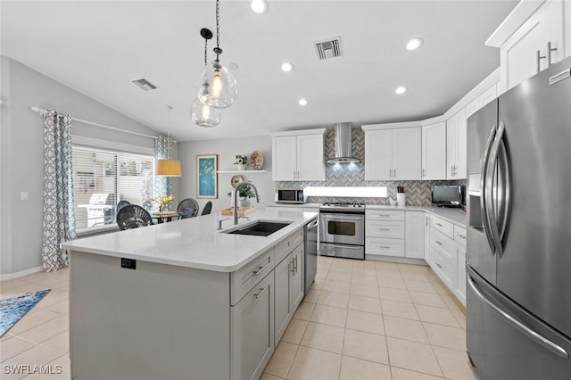 9109 Astonia Way, Estero, FL 33967 - kitchen with visible vents, wall chimney range hood, tasteful backsplash, a sink, and stainless steel appliances