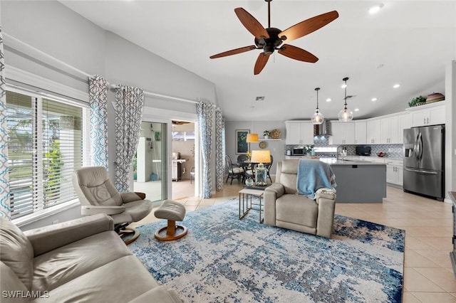 tiled living room featuring lofted ceiling, sink, and ceiling fan