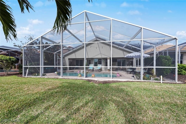 back of house featuring a yard, a patio, and glass enclosure