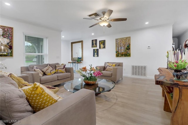 living room featuring ceiling fan and light wood-type flooring