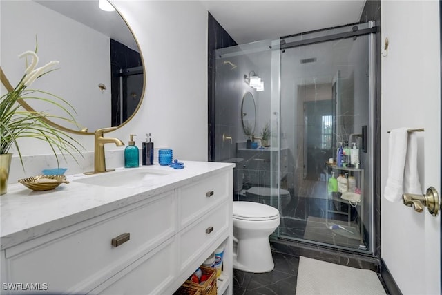 bathroom featuring vanity, a shower with shower door, and toilet