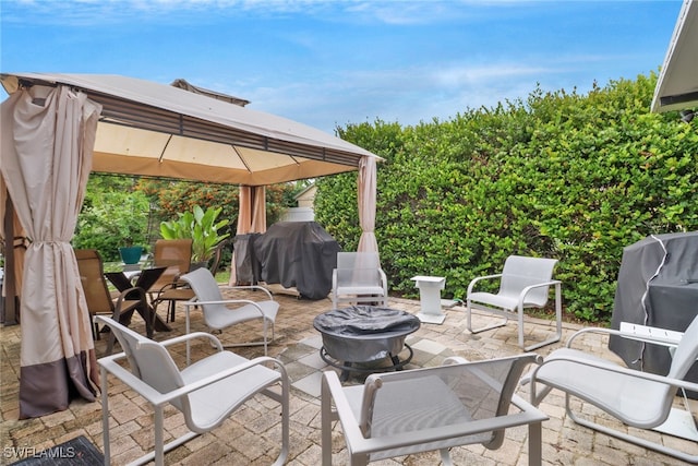 view of patio / terrace with a fire pit, a gazebo, and grilling area