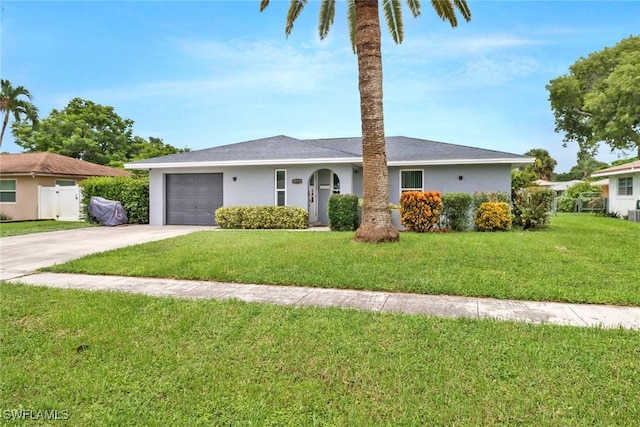 single story home featuring a garage and a front yard