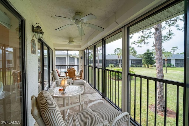 sunroom / solarium featuring ceiling fan