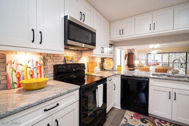 kitchen with tasteful backsplash, sink, black appliances, and white cabinets