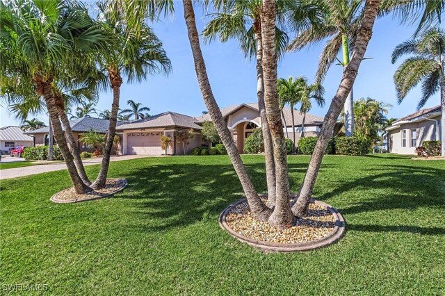 ranch-style house with a garage and a front lawn