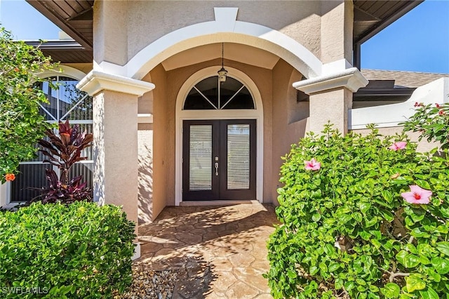 view of exterior entry featuring french doors