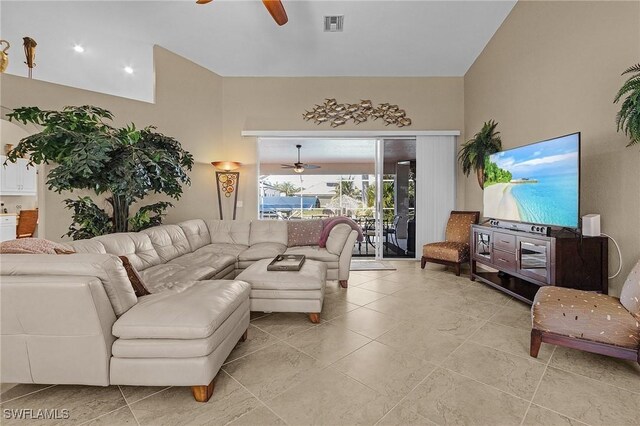 living room featuring a high ceiling and ceiling fan