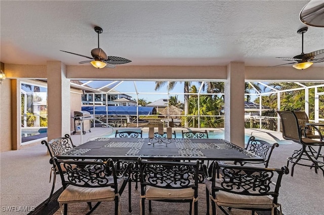 view of patio / terrace with glass enclosure and grilling area