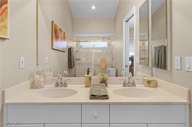 bathroom featuring vanity, an enclosed shower, and toilet