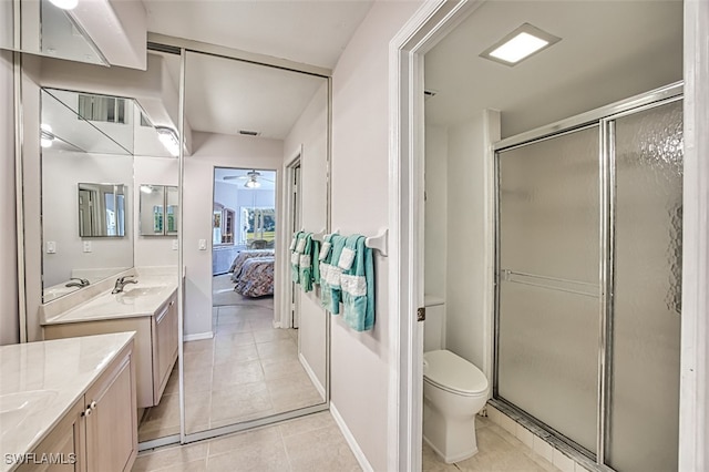 bathroom with walk in shower, tile patterned floors, toilet, and vanity