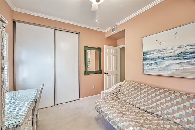 bedroom with crown molding, light colored carpet, a closet, and ceiling fan