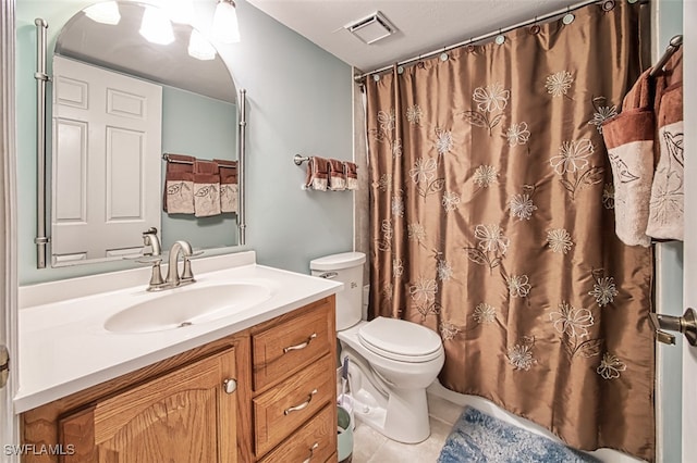 bathroom featuring tile patterned flooring, vanity, curtained shower, and toilet