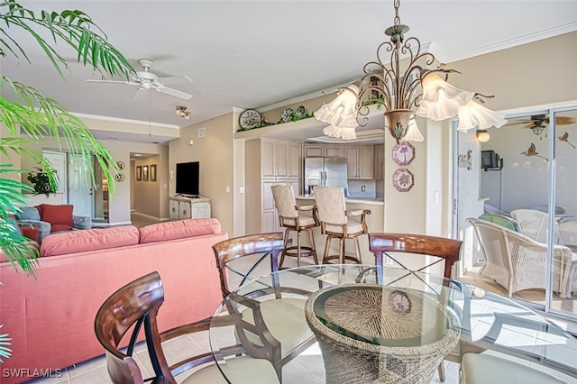 tiled dining area featuring ornamental molding and ceiling fan with notable chandelier