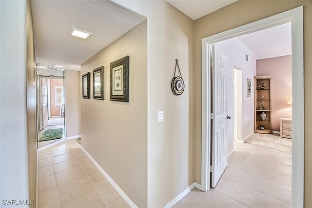 corridor featuring light tile patterned flooring