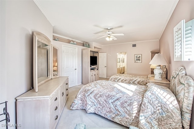 carpeted bedroom with ceiling fan and ornamental molding