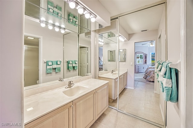 bathroom with ceiling fan, vanity, and tile patterned flooring