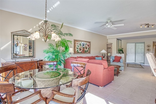 dining space featuring light tile patterned flooring, ornamental molding, and ceiling fan with notable chandelier