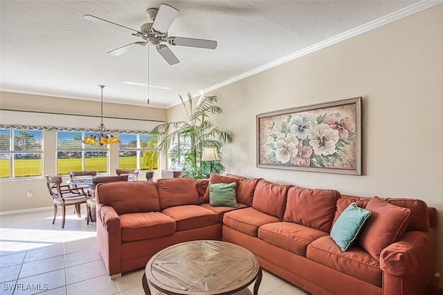 tiled living room with ceiling fan with notable chandelier and ornamental molding