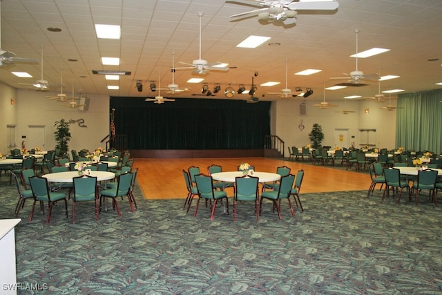 dining space with hardwood / wood-style flooring and a paneled ceiling