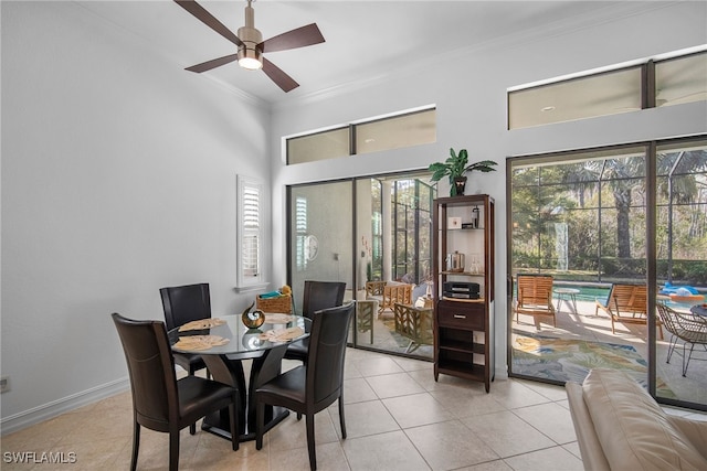 dining area with ornamental molding, light tile patterned floors, and ceiling fan