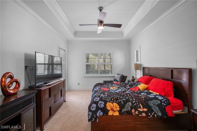 carpeted bedroom featuring crown molding, ceiling fan, and a tray ceiling