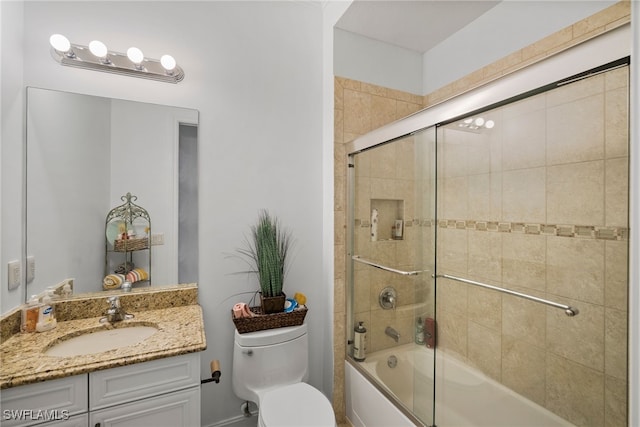 full bathroom with vanity, shower / bath combination with glass door, and toilet