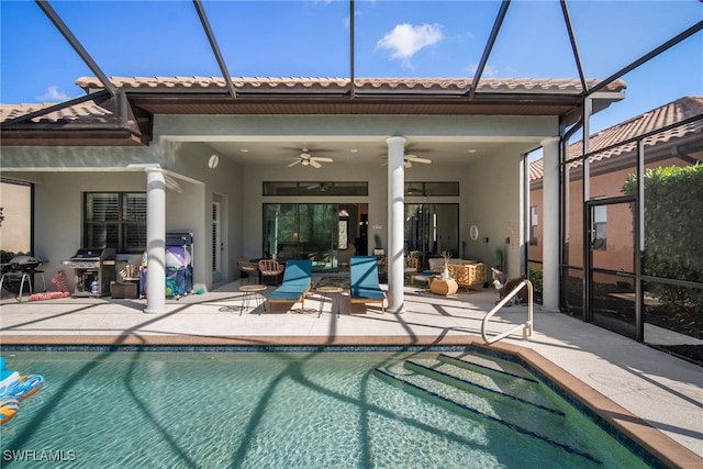 rear view of property featuring ceiling fan, a lanai, and a patio