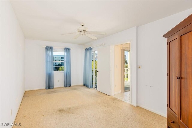 empty room with light colored carpet and ceiling fan