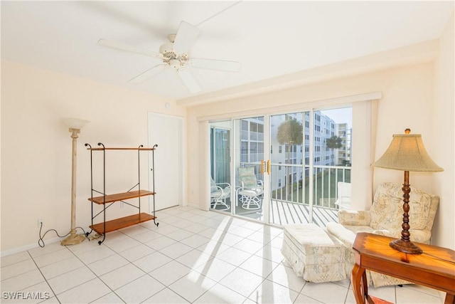 sitting room with ceiling fan and light tile patterned floors