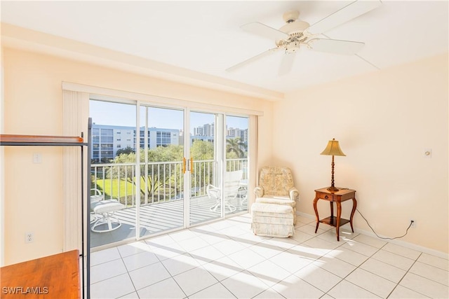 unfurnished room featuring ceiling fan and light tile patterned floors