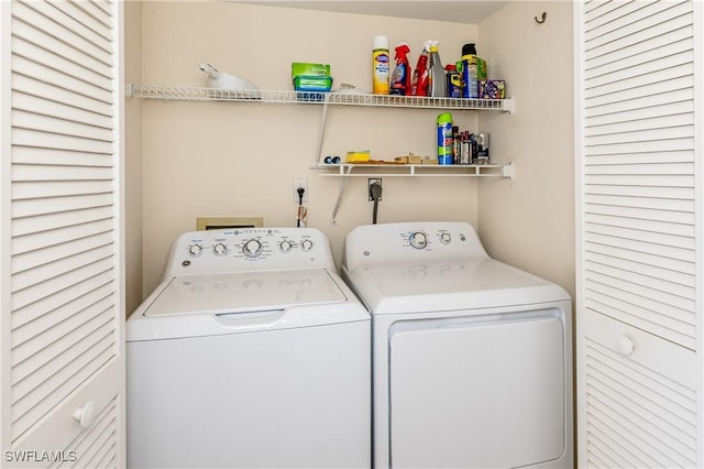 clothes washing area featuring washing machine and clothes dryer