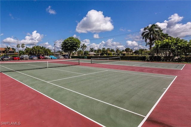 view of tennis court with basketball hoop