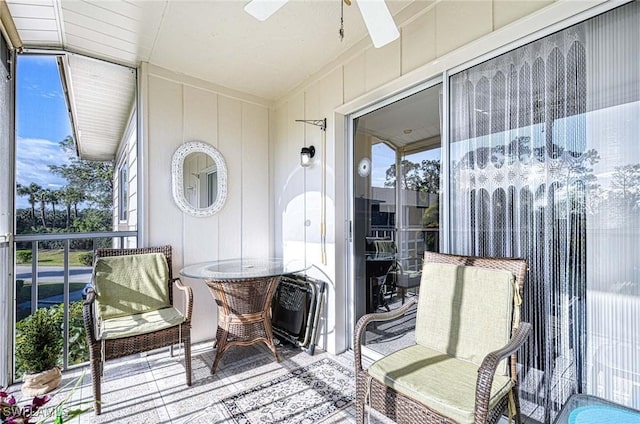 sunroom / solarium featuring ceiling fan