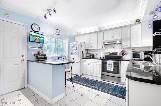 kitchen with a kitchen breakfast bar, white cabinetry, white appliances, and kitchen peninsula