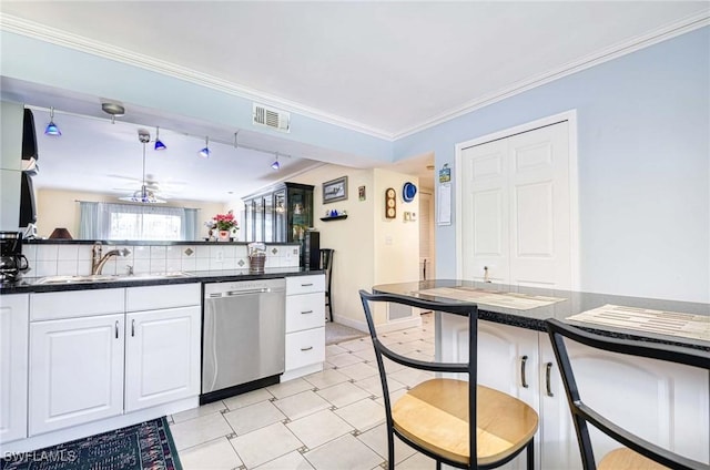 kitchen featuring sink, white cabinets, stainless steel dishwasher, ceiling fan, and crown molding