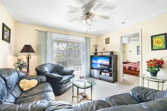 carpeted living room with crown molding and ceiling fan