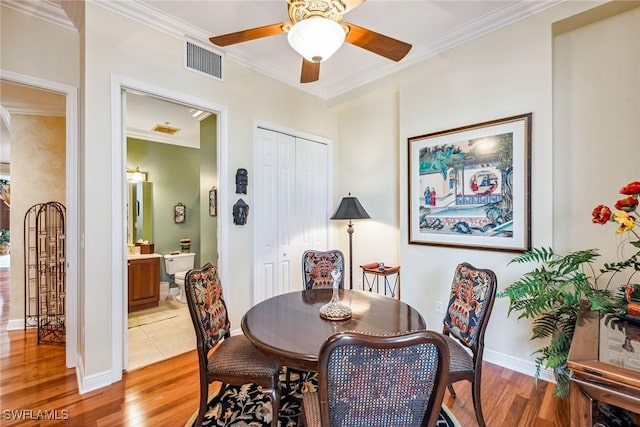 dining space featuring crown molding, ceiling fan, and light hardwood / wood-style floors