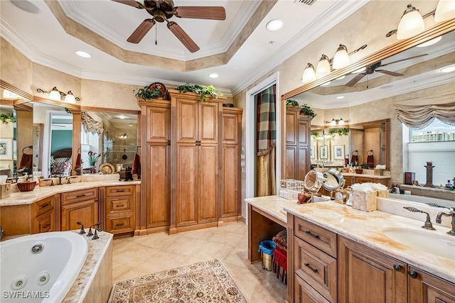 bathroom featuring ceiling fan, vanity, ornamental molding, a raised ceiling, and shower with separate bathtub